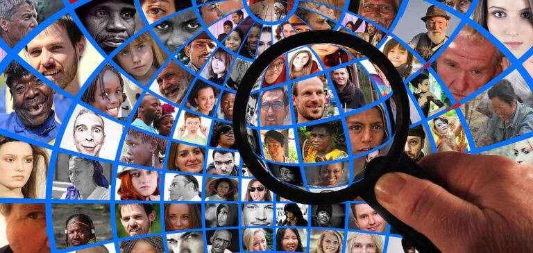 Magnifying glass over a globe made of many faces