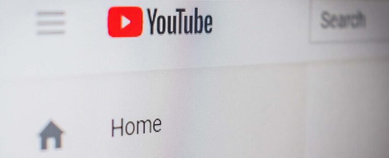 Close-up of the YouTube logo and Home menu on a screen