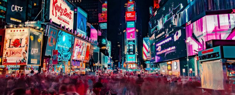 Times Square at night covered in bright digital billboards