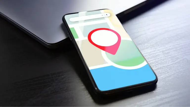 Phone on a table showing a map with a location pin