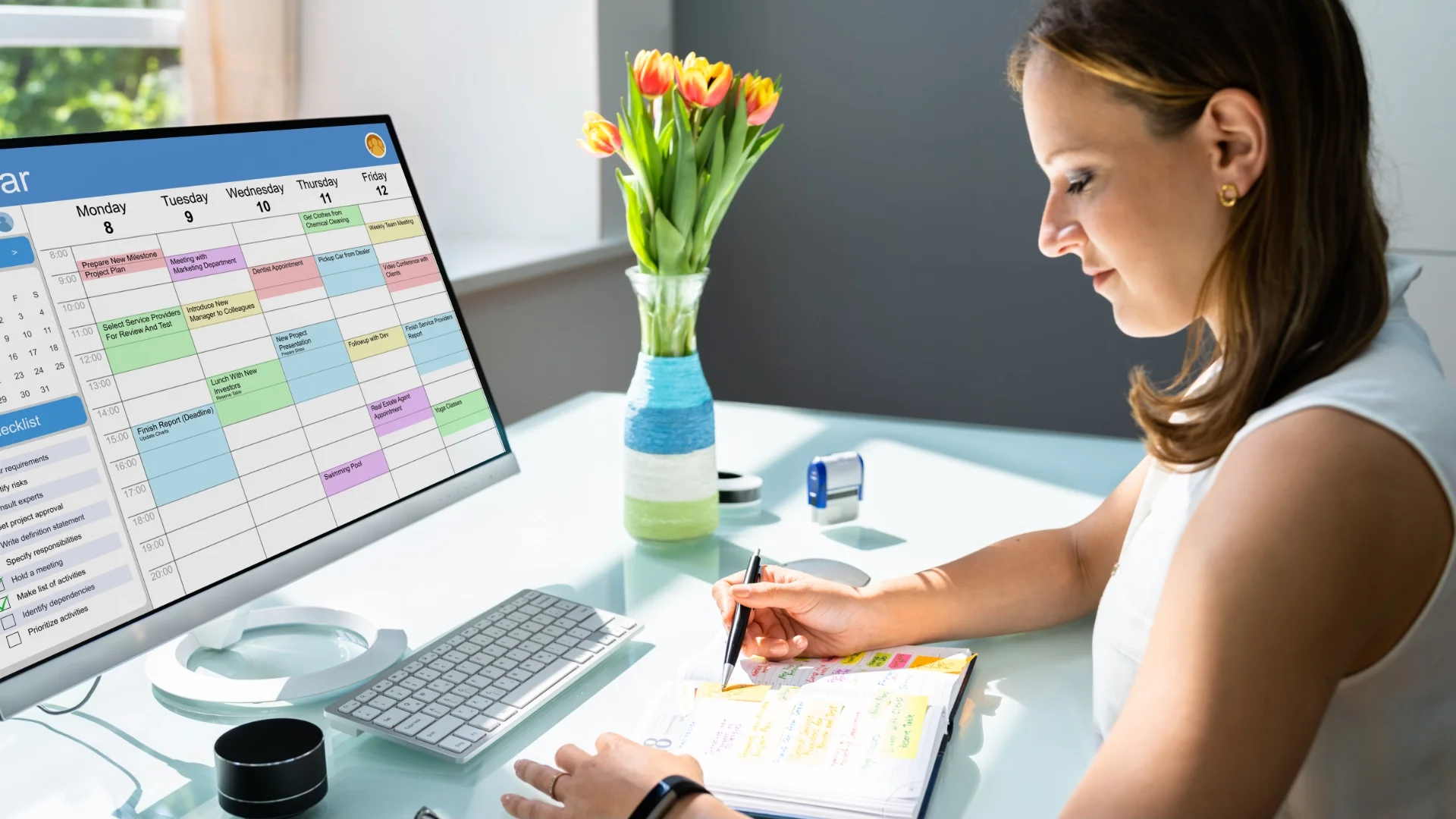 Woman planning a content calendar at her desk with a schedule on screen