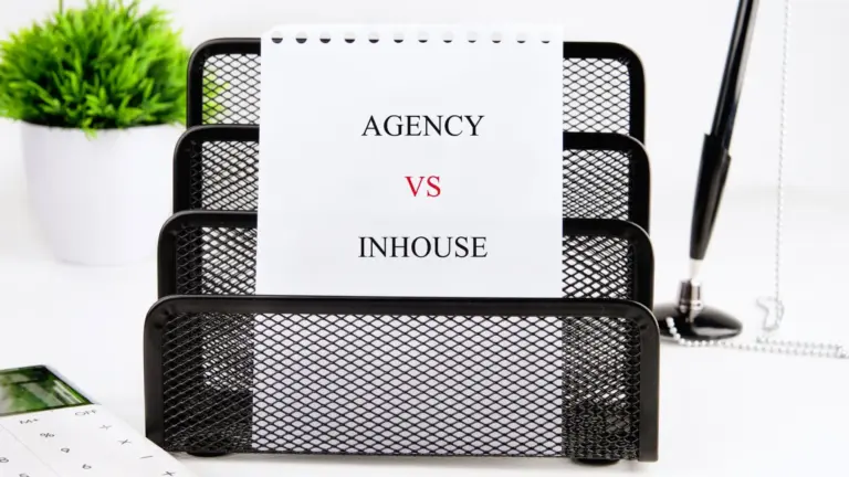 Desk tray holding a card that reads Agency vs In-house