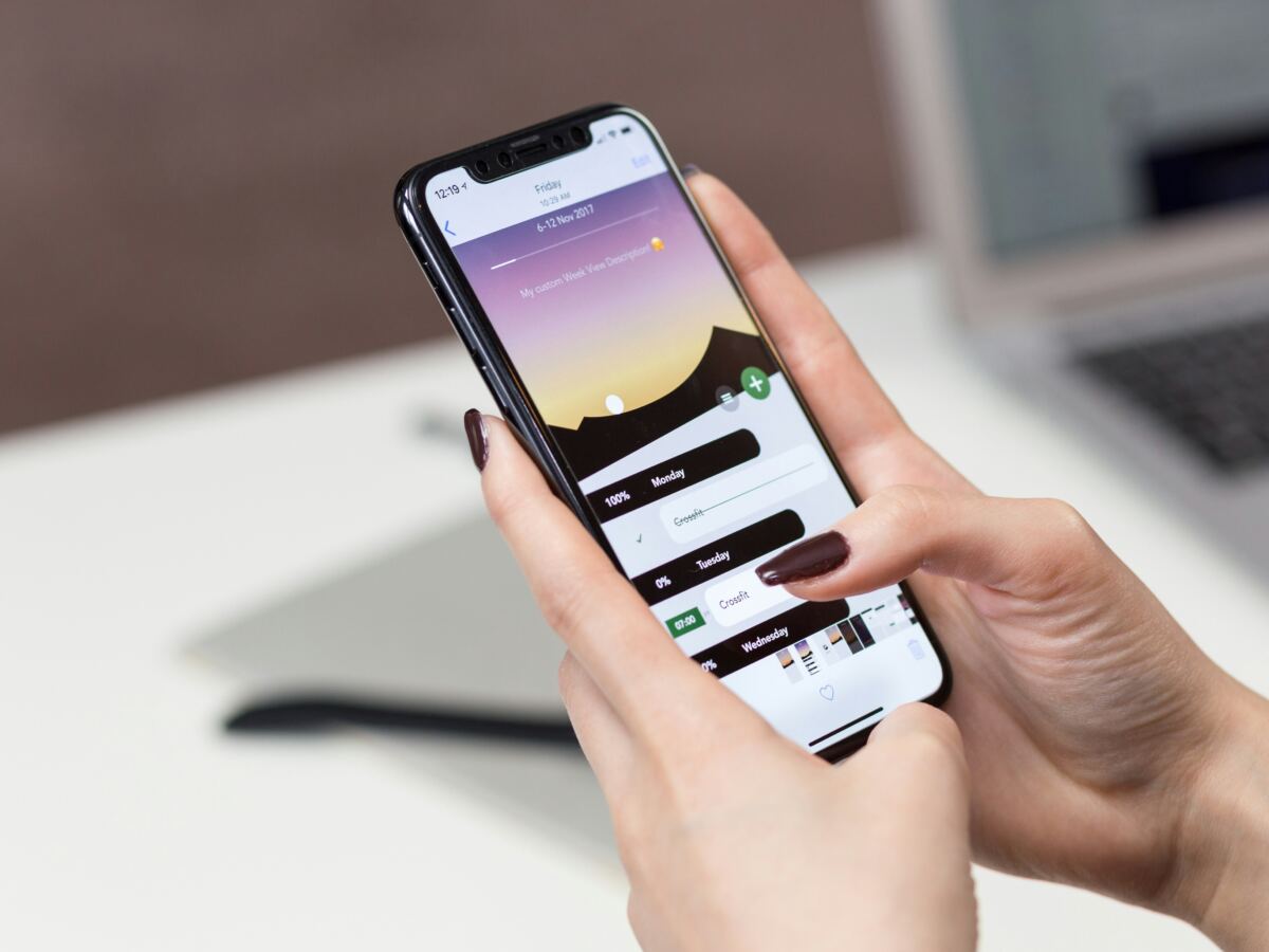 Hands holding a smartphone with a chat app open