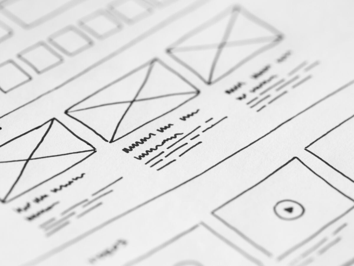 Hand-drawn website wireframes on white paper
