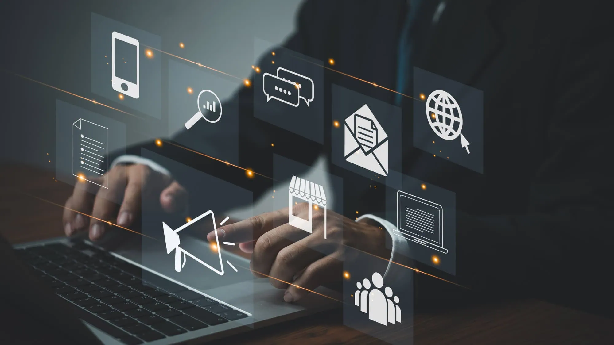 Hands on a laptop keyboard beneath floating icons for email, social media, video and web content