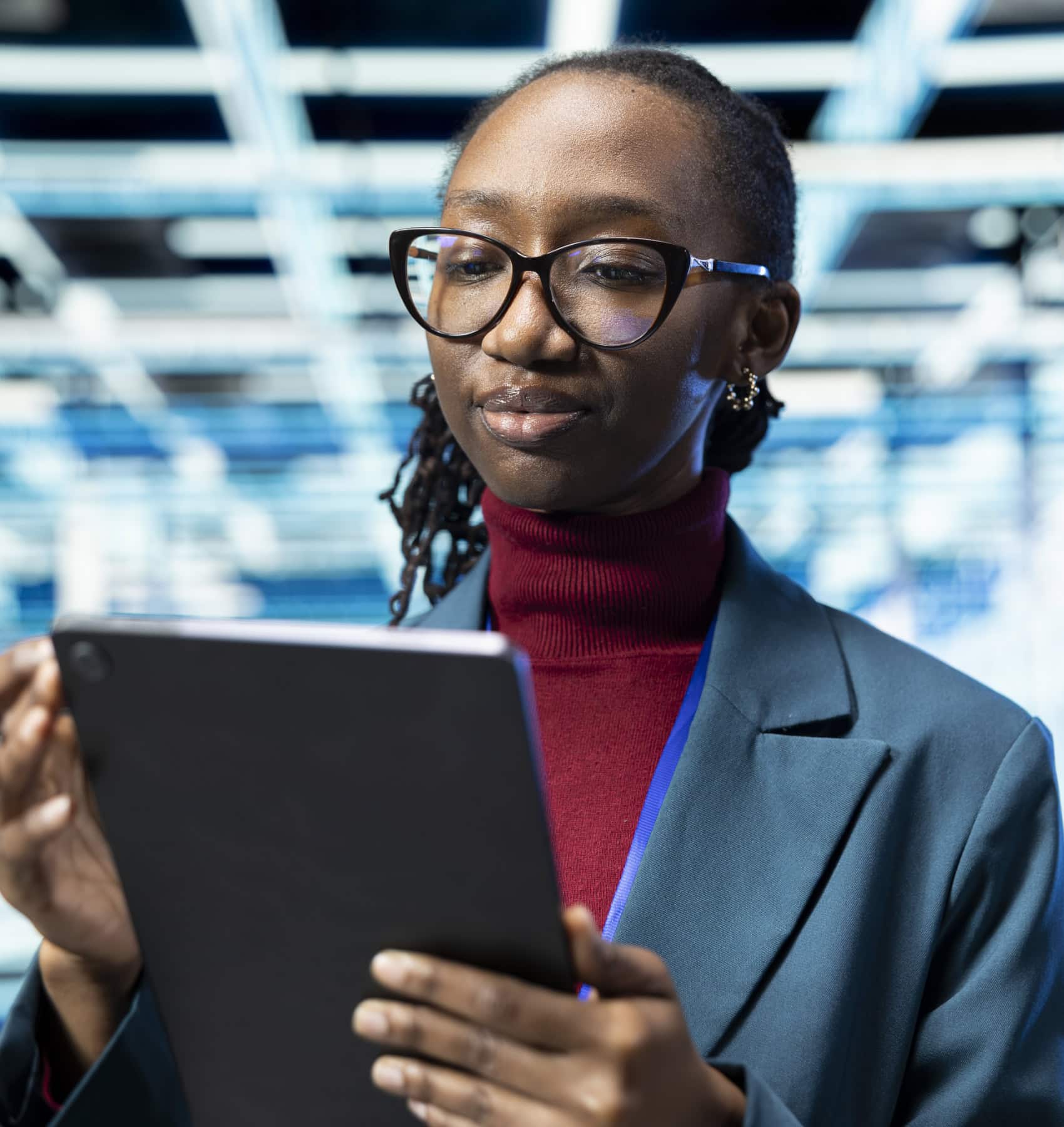 Woman in glasses using a tablet in a modern office