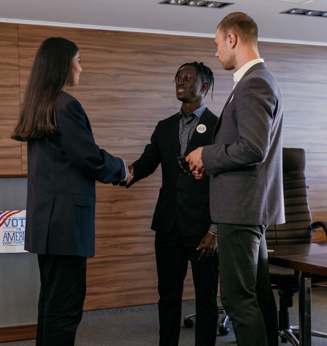 Professionals shaking hands after a meeting in a boardroom