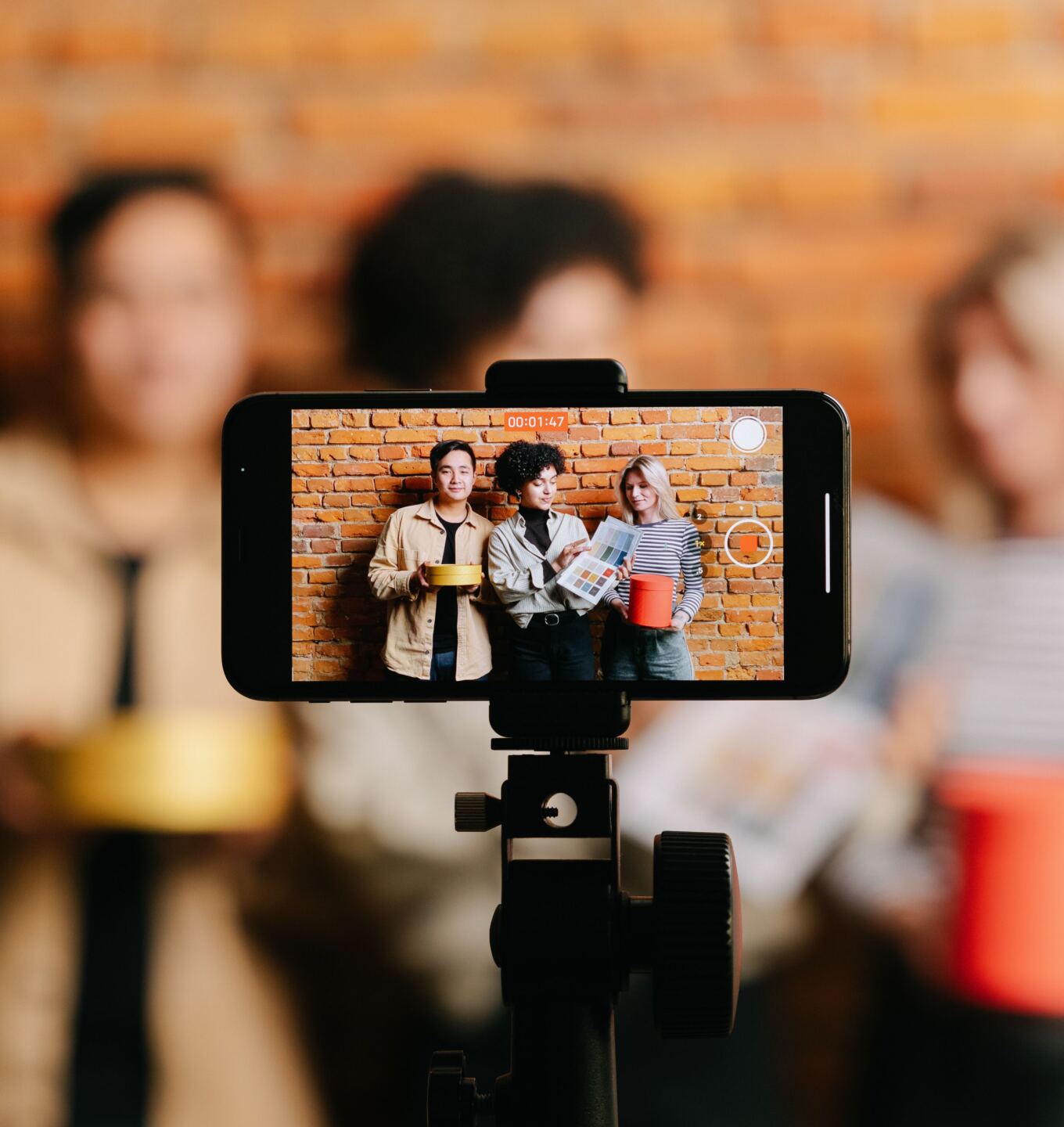 Phone on a tripod recording a group of friends for a video