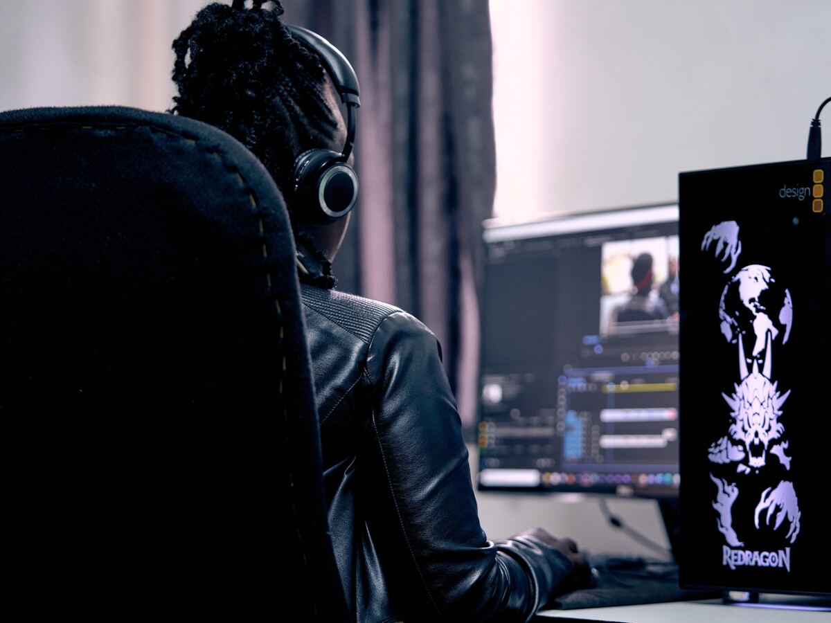 Video editor at a dual-monitor editing workstation