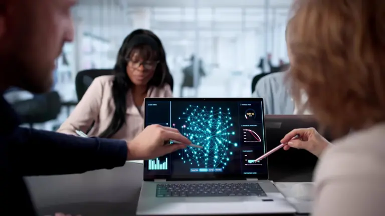 Colleagues reviewing a data visualisation on a laptop in a meeting